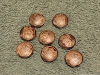 Front view showing 9 gold-tone button covers with a crown emblem on each.