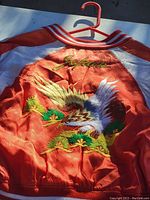 Back of the jacket showing detailed embroidery of an eagle flying over pine trees with Japanese characters.