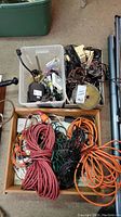 View of exterior shot showing boxes containing extension cords and assorted electrical hardware packed together.