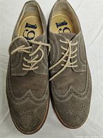 Top view of the gray suede men's wingtip brogue shoes showing lace-up and brogue detailing.