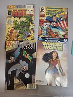 Photo showing four comic books: The Incredible Hulk, The Amazing Spider-Man, Batman & Robin Adventures, and Wonder Woman.
