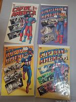 Photo of 4 Captain America comic books arranged in a 2x2 grid displaying colorful covers showing Captain America and comic scenes.