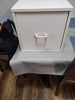 White cube-shaped file cabinet showing front view with handle.