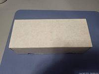 Closed white storage box used to hold NFL football cards.