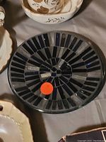 Round mosaic plate with black and gray tile design