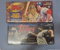 Two unopened sealed boxes of Topps Major League Baseball cards from 1999 and 2000, showing front packaging artwork and player images.