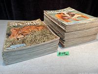 Two stacks of vintage Sports Illustrated magazines from 1954 and 1955 shown together to illustrate quantity and condition.