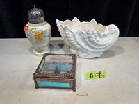 Three items pictured: Coalport sea shell vase, antique sugar caster with floral design, small mirrored trinket box.