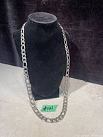 Full view of chain displayed on black bust showing overall length and link style