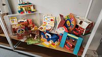 Overview of all Fisher-Price Little People toys and critter playset on shelf