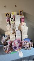 View of all boxed Precious Moments figurines stacked with four collector plates displayed in front