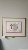 Full view of framed serigraph artwork showing Cinderella and Prince Charming dancing. The frame is gold with some paint peeling.