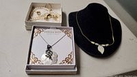 Annika Witt sterling silver necklace in box with two costume jewelry sets including gold-tone bracelet and earrings.