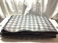 Grey checkered side of the weighted blanket folded flat.