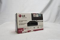Box of LG SP5 Network Media Player with printed product details and multimedia logos.