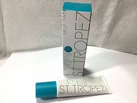 White tube and box of ST. Tropez Self Tan Bronzing Lotion Face 50ml with teal accents.