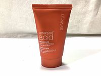 Front view of StriVectin Advanced Acid Resurface NIA-114 + Glycolic Skin Reset Mask 50ml in orange squeeze tube with white text showing product name and brand.