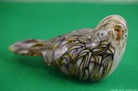 Clear side view of the colorful Murano style art glass bird showing detailed feather pattern and smooth glass finish.