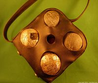 Top view of the black leather carrying case showing cutouts holding the four bocce balls.