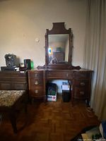 Front view of antique wooden dressing table with attached adjustable mirror, showing overall good condition with some wear.