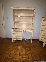 Front view of cream and gold wood desk with hutch showing overall condition and style.