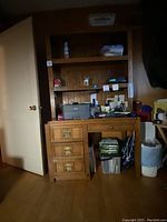 Full frontal view of the solid wood desk with hutch including drawers and shelves. Shows overall condition and wear.