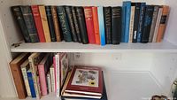 Shelf of assorted books including Alex Haley and historical titles.