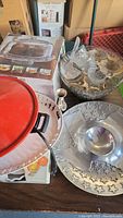 Overview of the serveware including metal, glass bowls, tray, wok and cake plate