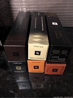 Six boxes of Nespresso Vertuo coffee pods arranged for photo showing various flavors