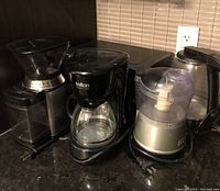 Photo showing coffee grinder, Salton coffee maker, and mini food processor on counter.