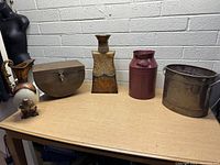 Full lot of six decorative metal items displayed on a table