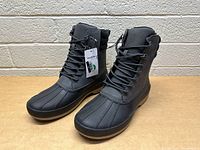 Side angled view of new black GoodFellow men's boots showing waterproof design, laces, and padded ankle collar.