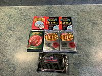 Seven sealed sports card packs arranged in two rows on carpet: 3 Topps Stadium Club 1991 baseball, 1 Score 92 football, 2 Fleer Ultra 1991 football, and 1 Pro Line NFL football pack.