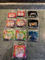 Photo showing all 10 McDonald's Hot Wheels toy cars sealed in original 1990s packaging arranged in two rows.