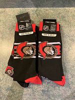 Two packs of Ottawa Senators NHL crew socks showing the front logo and packaging