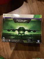 Front of original box for Xbox 360 Tom Clancy Splinter Cell Blacklist remote controlled plane showing plane image and branding.