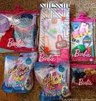 Photo of six individual Barbie accessory packages including clothing, roller skates, Color Reveal bags and small accessory packs