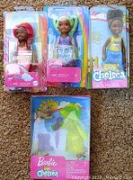 Three Barbie Club Chelsea dolls in original packaging, showing diverse doll designs and colorful backgrounds.