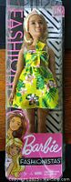 Barbie Fashionista Doll #126 in original packaging, showing front view of doll with yellow tropical floral dress and blonde hair