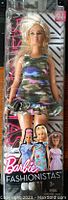 Front view of Barbie Fashionistas Doll #94 in original packaging, showing the doll wearing a camouflage dress.