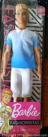 Front view of new Ken Fashionista male doll #129 in original packaging, showing doll with blue ombre shirt and white shorts