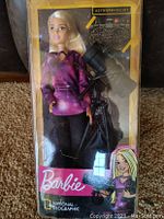 Front view of Barbie Astrophysicist doll in original box showing doll and telescope accessory inside.