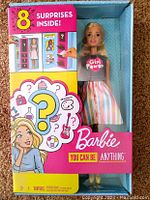 Front view of Barbie You Can Be Anything doll in original box showing the doll and the note of 8 surprises inside.