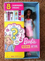Front view of Barbie You Can Be Anything doll in packaging showing doll and indications of 8 surprises inside