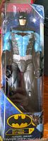 Photo of Batman Bat-Tech action figure in original sealed box with clear plastic front and colorful cardboard back, showing figure and logos.