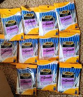 Photo showing 10 unopened packs of BIC Cristal ballpoint pens, each pack contains 10 pens with blue caps.