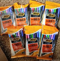 Seven unopened packs of BIC Cristal Xtra Bold pens, each pack contains 8 pens in assorted colors.