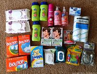Photo of new miscellaneous household and personal care items including wipes, soaps, hair dye, dryer sheets, and dental floss
