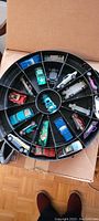 Open case showing rotating tray with 21 cars installed