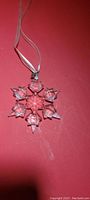 Six-pointed broad-arm leaf-shaped snowflake ornament on ribbon